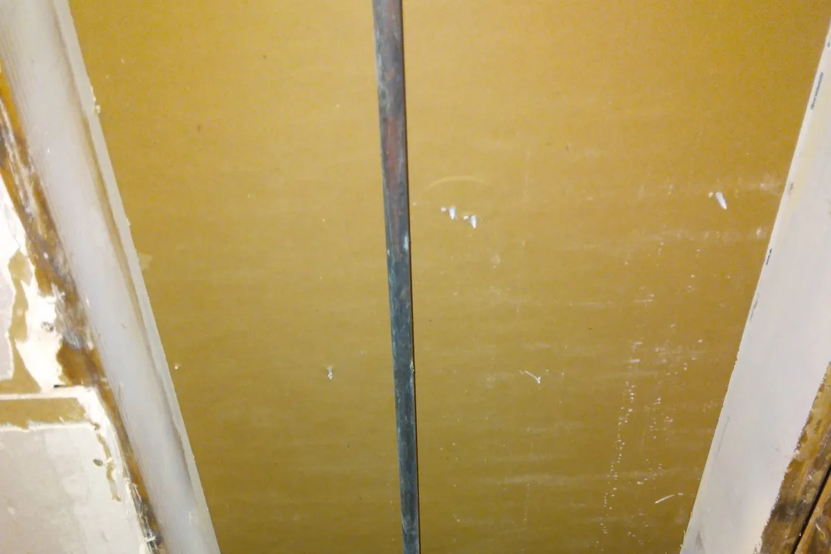 Handyman repairing plumbing under a sink